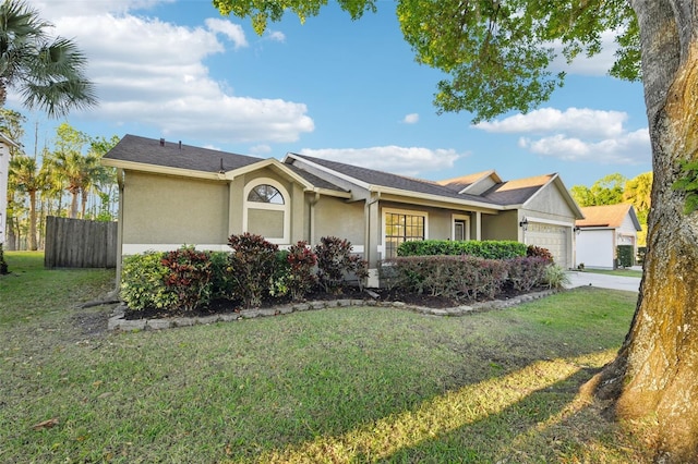 single story home featuring stucco siding, fence, concrete driveway, a front yard, and a garage