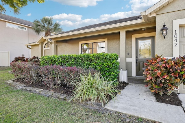 property entrance with stucco siding