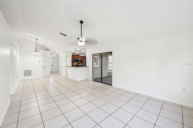 unfurnished living room with light tile patterned flooring, visible vents, a ceiling fan, and vaulted ceiling