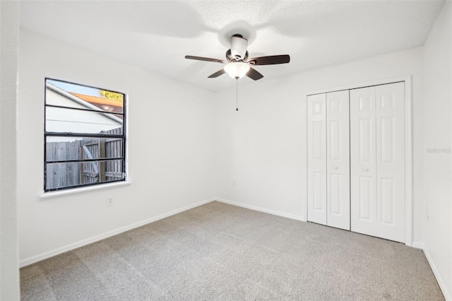 unfurnished bedroom featuring a closet, baseboards, and carpet