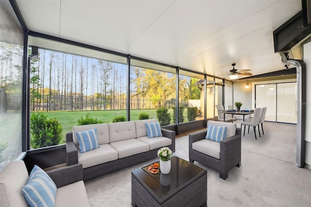 sunroom / solarium featuring a ceiling fan