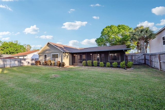 rear view of property with a yard, a fenced backyard, and stucco siding