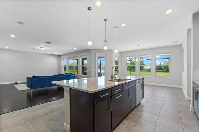 kitchen featuring light tile patterned floors, visible vents, dishwasher, and a sink