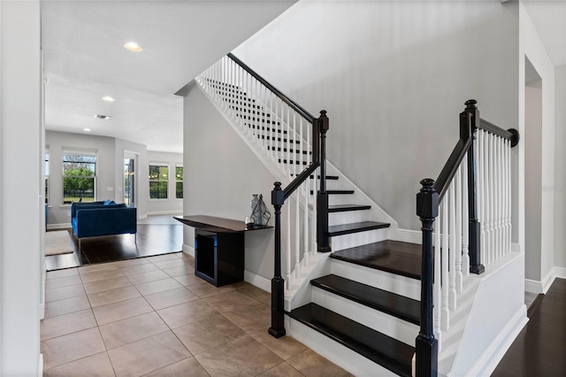 staircase with tile patterned flooring, recessed lighting, and baseboards