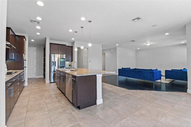 kitchen with visible vents, dark brown cabinetry, open floor plan, stainless steel appliances, and a sink