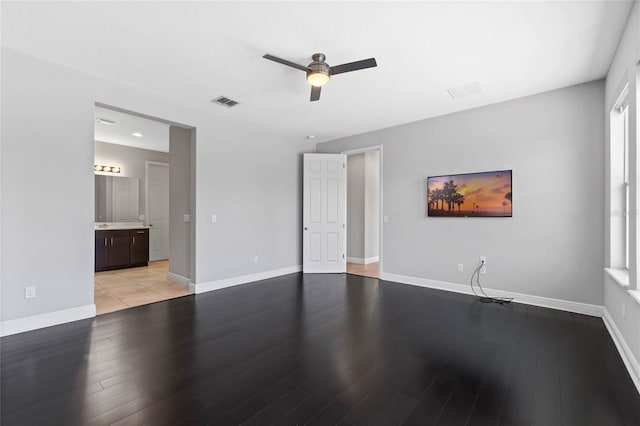 interior space with light wood-type flooring, baseboards, and a ceiling fan