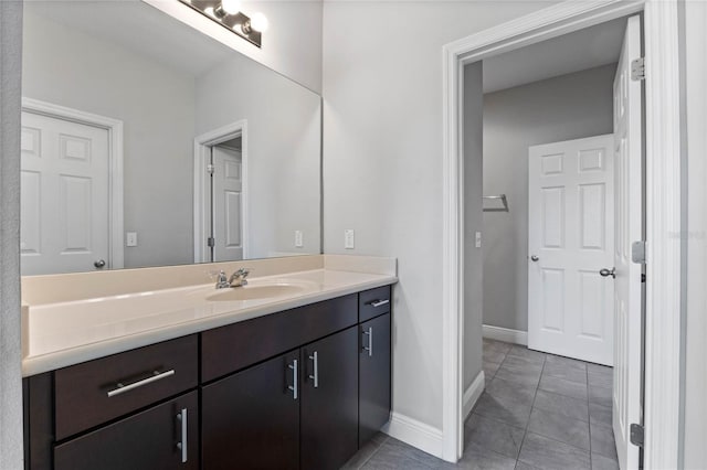 bathroom featuring vanity, tile patterned floors, and baseboards