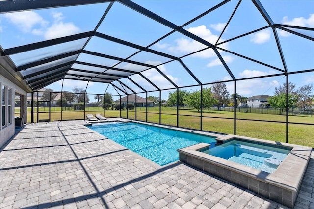 view of pool featuring glass enclosure, a patio, a lawn, and a pool with connected hot tub