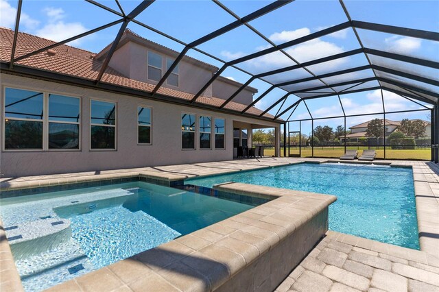 view of pool with a lanai, a pool with connected hot tub, and a patio