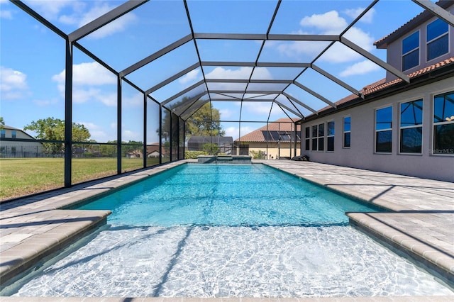 view of swimming pool featuring glass enclosure, a patio, a yard, and a pool with connected hot tub