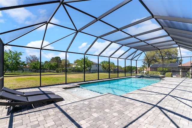 view of pool featuring glass enclosure, a patio, a yard, and a pool with connected hot tub