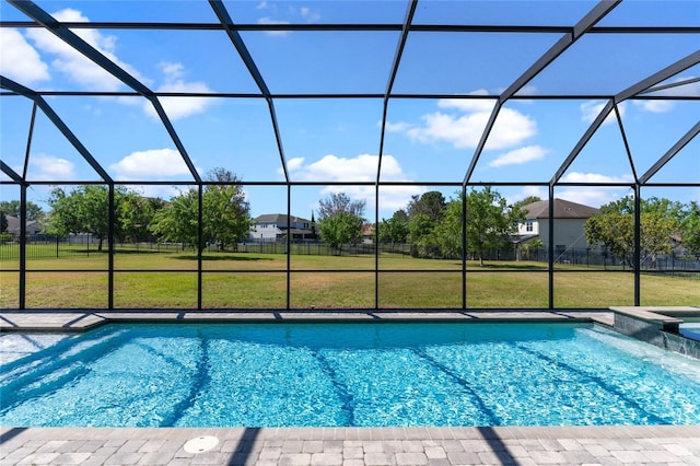 view of swimming pool with a yard, glass enclosure, and a pool with connected hot tub