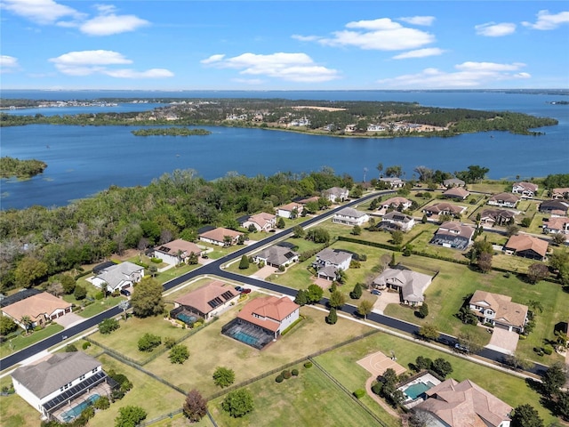 drone / aerial view featuring a residential view and a water view