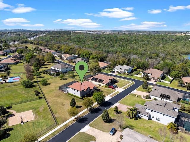 birds eye view of property with a residential view and a wooded view