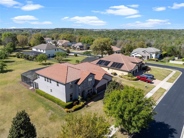 aerial view featuring a forest view and a residential view