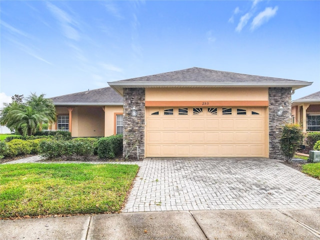 view of front of home with stone siding, stucco siding, an attached garage, and decorative driveway