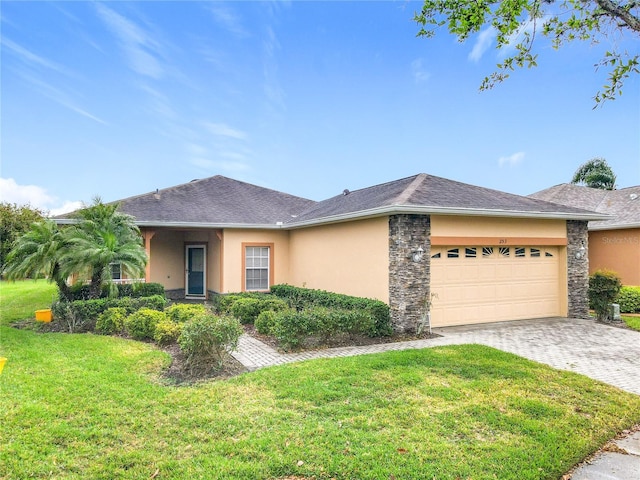 view of front facade with stucco siding, decorative driveway, a garage, and a front lawn