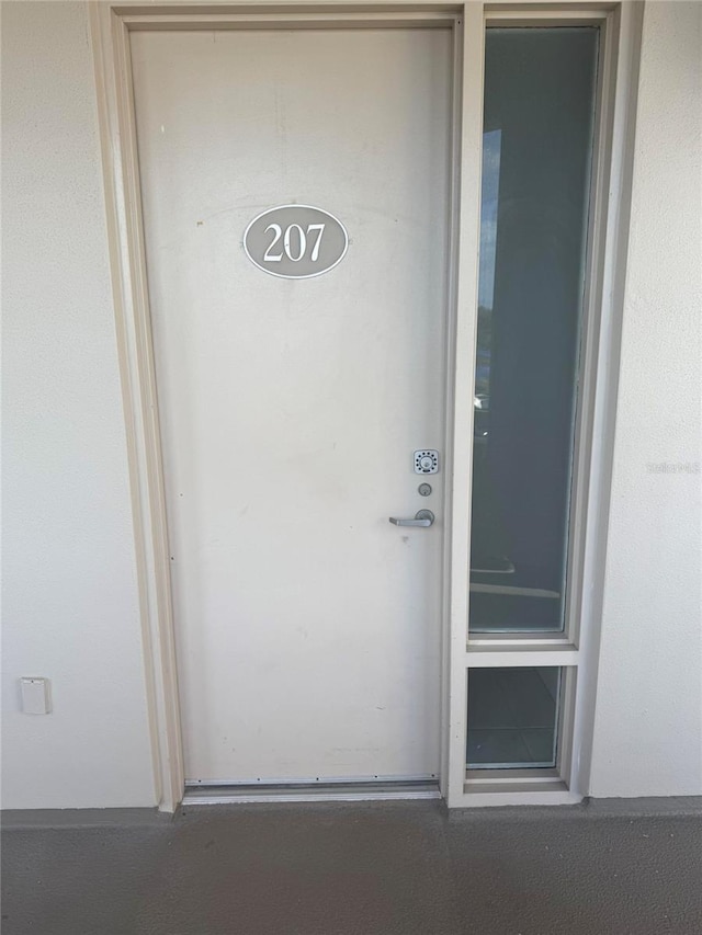 entrance to property with stucco siding