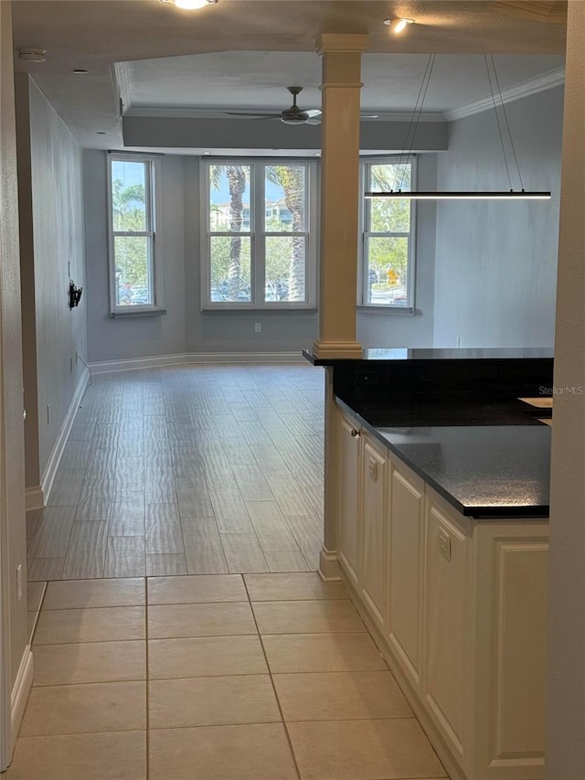 kitchen featuring crown molding, decorative columns, open floor plan, and a wealth of natural light