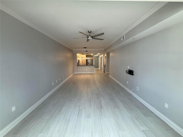 unfurnished room with visible vents, baseboards, light wood-style flooring, ornamental molding, and ceiling fan