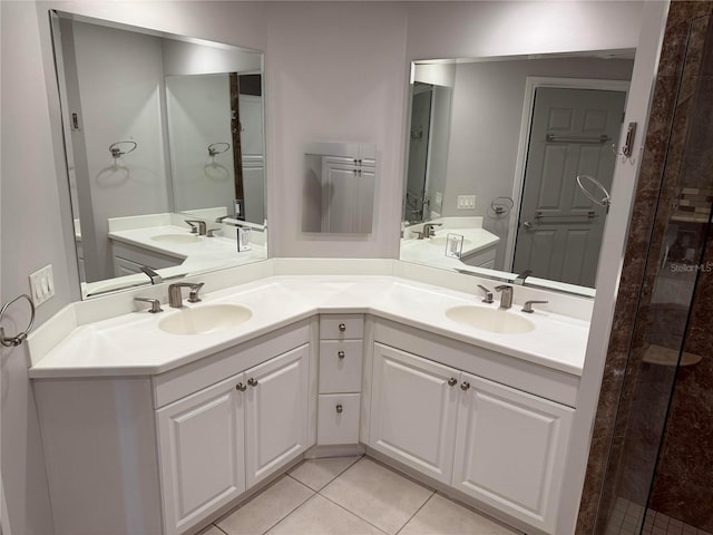 bathroom featuring tile patterned flooring, double vanity, and a sink