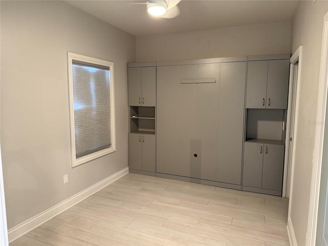 empty room featuring baseboards and wood tiled floor