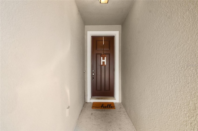 property entrance featuring stucco siding