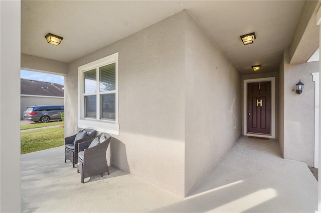 doorway to property featuring stucco siding