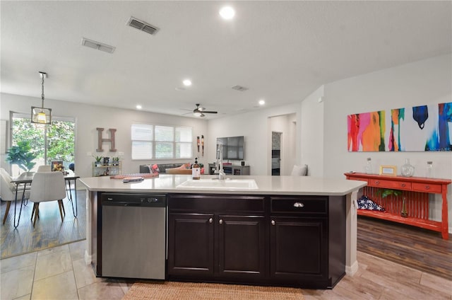 kitchen featuring dishwasher, light countertops, ceiling fan, and a sink