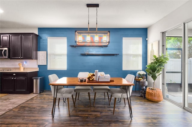 dining space with wood finished floors