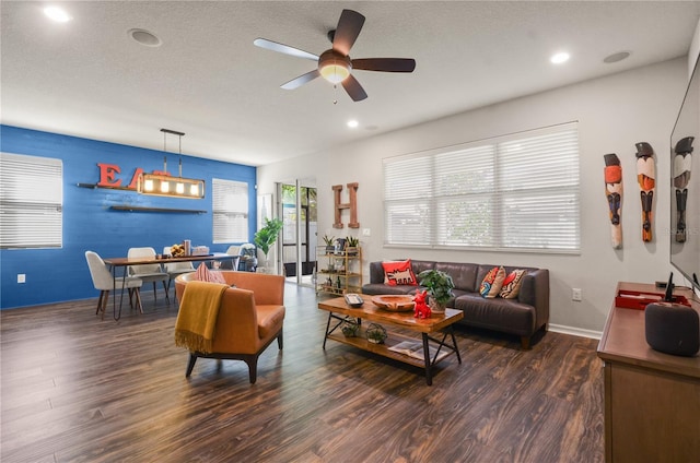 living area featuring baseboards, ceiling fan, recessed lighting, wood finished floors, and a textured ceiling