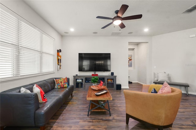 living room with visible vents, ceiling fan, baseboards, and wood finished floors