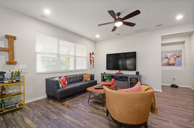 living room featuring baseboards, wood finished floors, visible vents, and ceiling fan