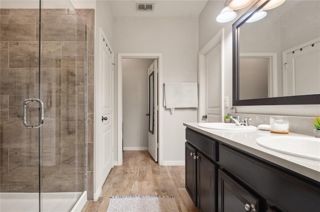 bathroom featuring a sink, visible vents, and a stall shower