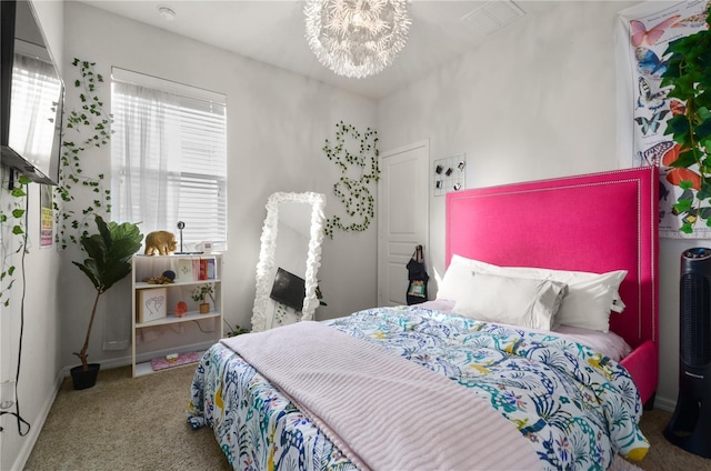 carpeted bedroom with a chandelier