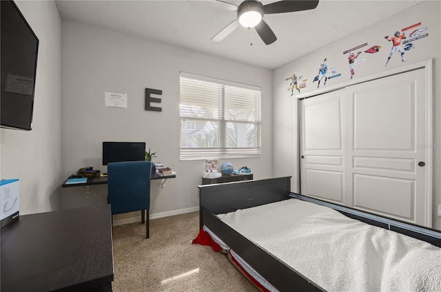 carpeted bedroom with baseboards, a closet, and ceiling fan