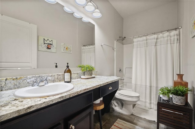 full bath featuring toilet, vanity, and shower / bath combo with shower curtain