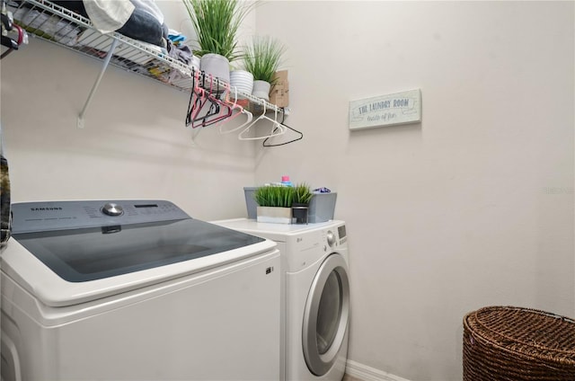 laundry area with washer and dryer, baseboards, and laundry area