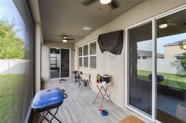 sunroom featuring ceiling fan