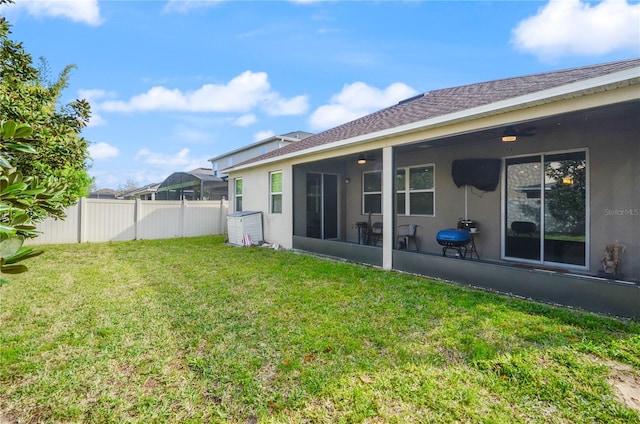 view of yard with a sunroom and fence