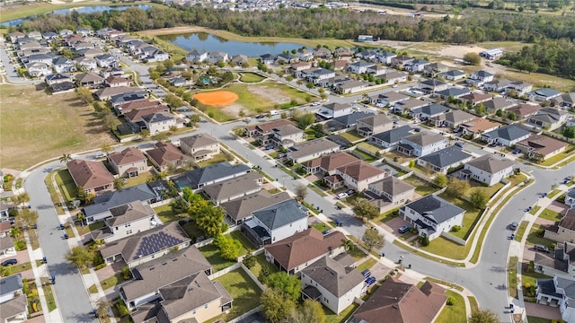 bird's eye view with a residential view and a water view