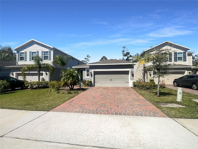 traditional home featuring a garage, stucco siding, driveway, and a front yard