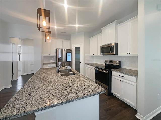 kitchen featuring backsplash, stainless steel appliances, and a sink