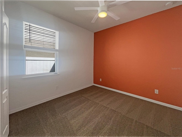 carpeted spare room with baseboards and ceiling fan