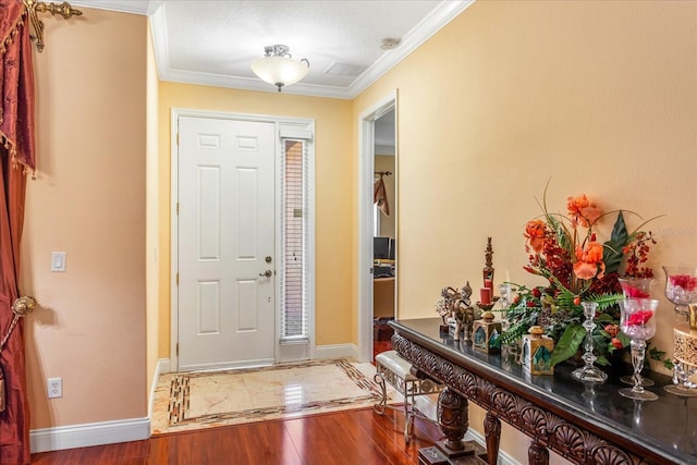 entryway with baseboards, wood finished floors, and ornamental molding