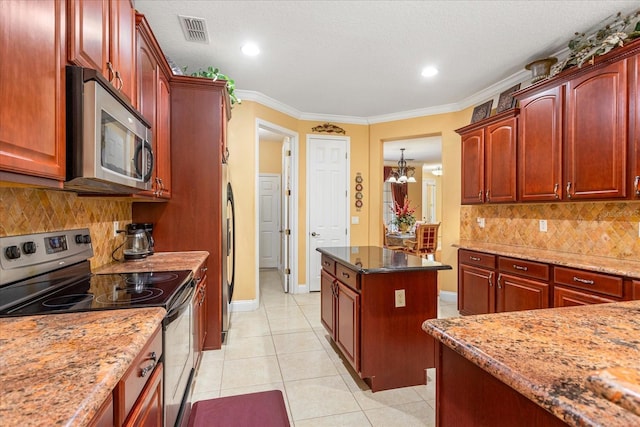 kitchen with light tile patterned floors, visible vents, dark brown cabinets, and stainless steel appliances