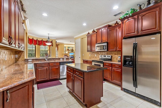 kitchen with light tile patterned floors, visible vents, stainless steel appliances, and a sink