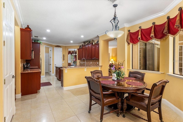 dining space featuring light tile patterned floors, baseboards, ornamental molding, and recessed lighting