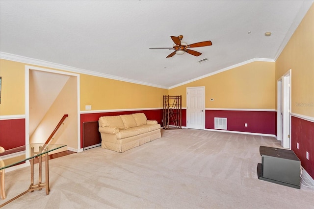 unfurnished room featuring carpet, visible vents, lofted ceiling, ceiling fan, and crown molding