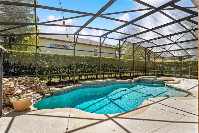 view of swimming pool with glass enclosure, a pool with connected hot tub, and a patio